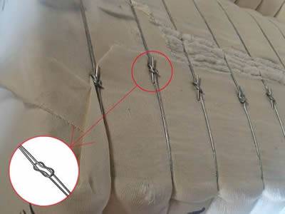 Quick link bale tie application for baling cotton.