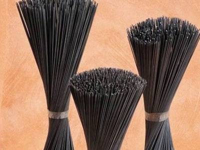 Black iron wire processed into three bundles of cut wires.