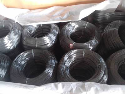 Many rolls of high carbon steel wire packaged in a white sack.