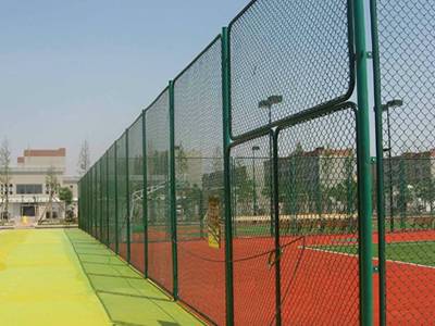 Redrawing galvanized wire is applied to chain link fence on playground.