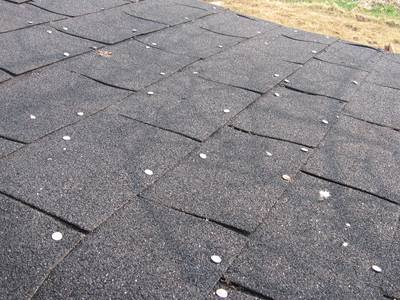 Roofing nails are used to fix plastic tiles on the ground.
