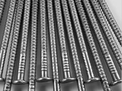 Many screwed thread roofing nails arranged in a row.