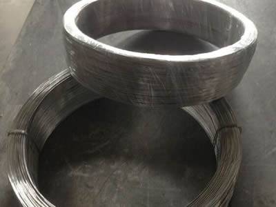 Two near coils of zinc wire on the ground.